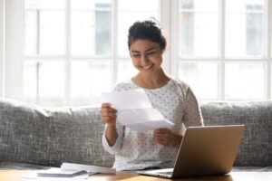 girl opening envelope with letter